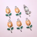 Detail of tulip pendants in orange and green enamel with silver metal frames for DIY crafts - Orange