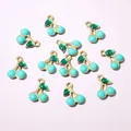 Macro detail of blue enamel cherry pendants with gold finish for DIY jewelry making - Light Blue Cherry Style (E6-69)