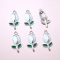 Detail view of six tulip flower pendants for DIY jewelry with glossy enamel finish - White