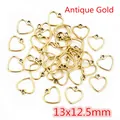 Macro view of multiple antique gold hollow heart charms for DIY jewelry making - Pointed Heart (13x12.5mm) / Antique Gold Style (AC3-42)