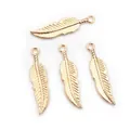 Close-up of four golden alloy feather charms with detailed texture for DIY jewelry making - KC Gold