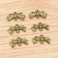 Sechs antike Bronze-Bogenanhänger mit Doppelösen für DIY-Schmuckherstellung - Bronze