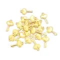 Detailed macro view of heart-shaped key charms in polished gold finish for DIY jewelry - Gold