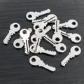 Macro shot of polished silver alloy key pendants for DIY jewelry making accessories - Antique Silver