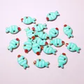 Detailed macro view of small blue fish pendants for DIY jewelry making accessories - Light Blue Striped Fish (E6-63)