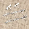 Antique silver dragonfly pendants for DIY jewelry making on textured linen background - Antique Silver