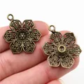Antique bronze flower pendant for DIY jewelry, 32x24mm hollow floral charms in palm - Bronze