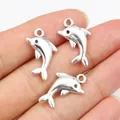 Alloy dolphin pendants for DIY jewelry making in antique silver finish on palm - Antique Silver