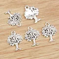 Five silver tree of life alloy charms for DIY jewelry on a rustic wooden background - Antique Silver