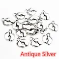 Antique silver baby footprint charms for DIY jewelry making in a scattered layout - Antique Silver
