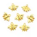 Macro shot of 20x16mm golden alloy bee charms with hanging loops for DIY jewelry - Gold