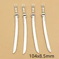 Macro shot of 4 antique silver alloy sword charms with size detail of 104x8.5mm - Black Dot Pattern Vintage Blade Style (E4-33)