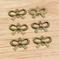 Set of 6 bronze alloy bow-shaped charms with double loops for DIY jewelry making - Bronze