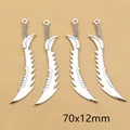 Detailed view of four antique silver sword charms measuring 70x12mm for DIY jewelry - Serrated Edge Ring Handle Pendant (E4-35)