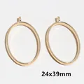 Detailed view of two gold-colored oval open frames for jewelry DIY size 24x39mm - Oval / 21x39mm