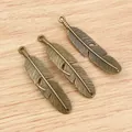 Three antique bronze feather pendants 57x13mm with detailed texture for DIY jewelry making - Bronze