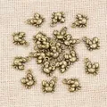 Antique bronze crab charms for DIY jewelry making on a rustic linen background - Bronze