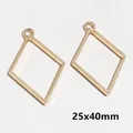 Detail view of two gold-plated rhombus frame charms for DIY jewelry making, 25x40mm size - Diamond / 25x40mm