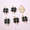 Vue détaillée de pendentifs trèfles 18x12mm en émail noir et base en métal doré - Noir
