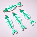 Macro detail of four gold fish bone charms with green and white enamel for DIY jewelry - Green and White Fish Bone Style (AJ5-12)