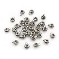 Detailed macro view of small silver stainless steel stopper beads for jewelry making - 3.4x2.5mm / Steel