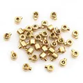 Macro detail of gold plated stainless steel jewelry stopper beads with side push buttons - 3x2.5mm / Gold