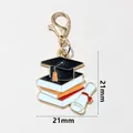 Detail of graduation cap and diploma charm with dimensions 21mm by 21mm - Cap Books And Scroll (SG-F6-23-AB1-02)