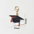 Gold-rimmed graduation cap and diploma enamel pendant with dimensions 23x27mm - Graduation Cap And Scroll (SG-E3-64-AB1-02)