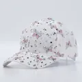 Detailed view of white lace baseball cap featuring pink butterfly and silver rhinestones - Adjustable / Pink