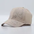 Detail of rhinestone butterfly and text embellishments on beige cotton baseball cap - Butterfly Pattern / Khaki