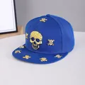Detail of blue flat brim hip-hop hat with gold skull studs and metallic rivets - Adjustable / Skull-Royal Blue