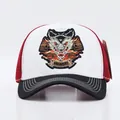 Dettaglio del ricamo a testa di lupo su cappellino baseball in mesh bianco e rosso - Regolabile / Leone Tesa Bianco Nera