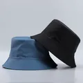 Close-up of blue and black bucket hats with reinforced stitched brims and canvas texture - One Size / Sea Blue And Black