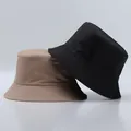 Detail view of stitched brim on black and khaki minimalist bucket sun hats - One Size / Khaki And Black