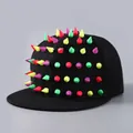 Punk black snapback hat with colorful metallic spikes and vibrant street style aesthetic - Colorful Rivets