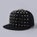 Detailed close-up of metallic silver studs on a black flat-brimmed streetwear baseball cap - Silver Rivets