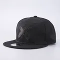 Close-up of black snapback hat featuring 3D embroidered X logo and twill texture detail - Adjustable / Hat Only / Black