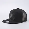 Detailed view of black flat brim trucker hat featuring artistic embroidered X logo and mesh - Adjustable / Trucker Hat / Black