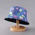 Detail of floral bucket hat with colorful flower print on a wooden stand - Blue Faux Denim Floral Print (23#)