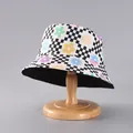 Detail of floral checkered bucket hat on wooden stand showing double-sided canvas texture - Black White Checkerboard Floral (24#)