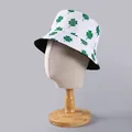 Detail of green four-leaf clover print on white bucket hat shown on a display mannequin - One Size / White Clover