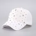 Close-up of white baseball cap with silver metal studs and 3D star-shaped ornaments - Adjustable / White Star Rhinestones