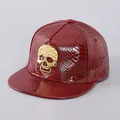 Detail of red faux snakeskin leather snapback cap with golden rhinestone skull ornament - Wine Red Skull
