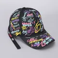 Detail of street style graffiti lettering and ribbon on a black cotton baseball cap - Black Yellow Graffiti Alphabet (Ribbon)