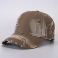 Close-up of vintage brown baseball cap featuring distressed holes and frayed fabric texture - Adjustable / Coffee Distressed Denim