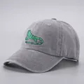 Dettaglio del ricamo a lucertola verde su un berretto da baseball grigio lavato - Regolabile / Lucertola ricamata grigio chiaro