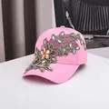 Pink baseball cap featuring large floral embroidery and sparkling rhinestones for women - Adjustable / Pink