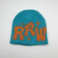 Close-up of fluffy faux mink knit beanie featuring blue body and orange RAW star pattern - One Size / Light Blue