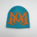 Close-up of fluffy faux mink knit beanie with orange jacquard letter M design - One Size / Light Blue Large M