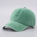 Close-up of a washed cotton baseball cap in green with reinforced visor stitching - Adjustable / Pure Cotton Soft Top - Green